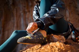 woman putting on beginner rock climbing shoes