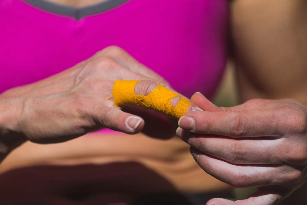 woman climber finger taping