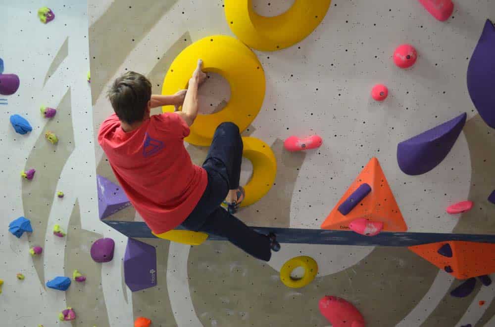 man bouldering indoors