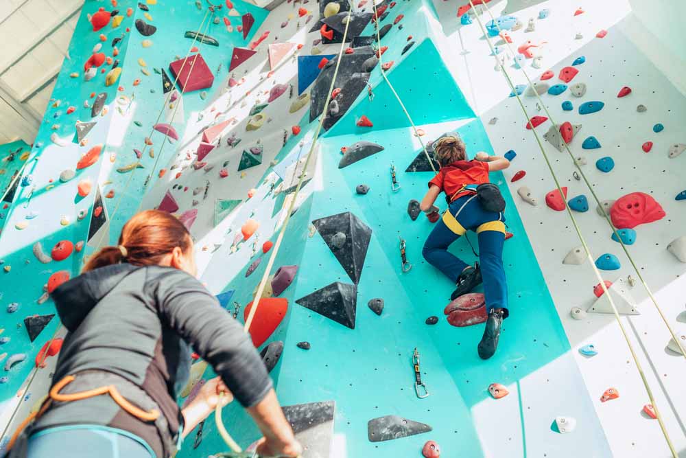 woman showing how to belay a child