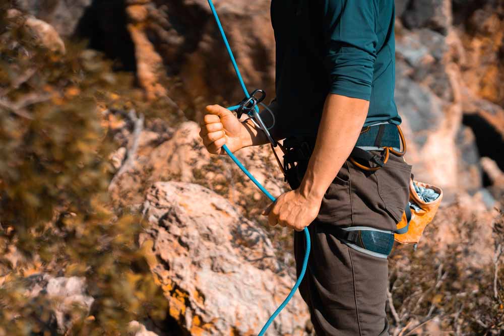 man belaying a climber