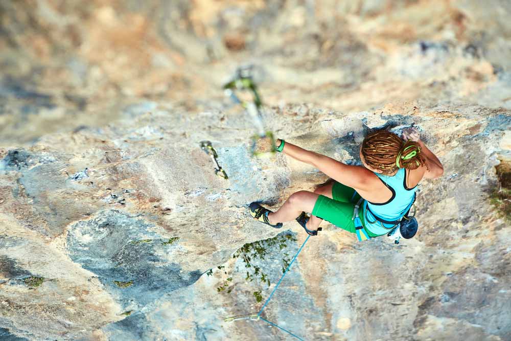 woman climbing on crux sequence