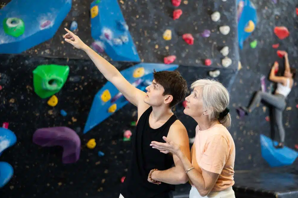 yound climber providing beta to older woman