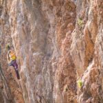 woman climbing hard grade route