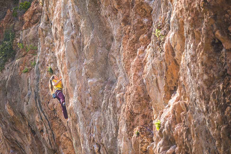 woman climbing hard grade route