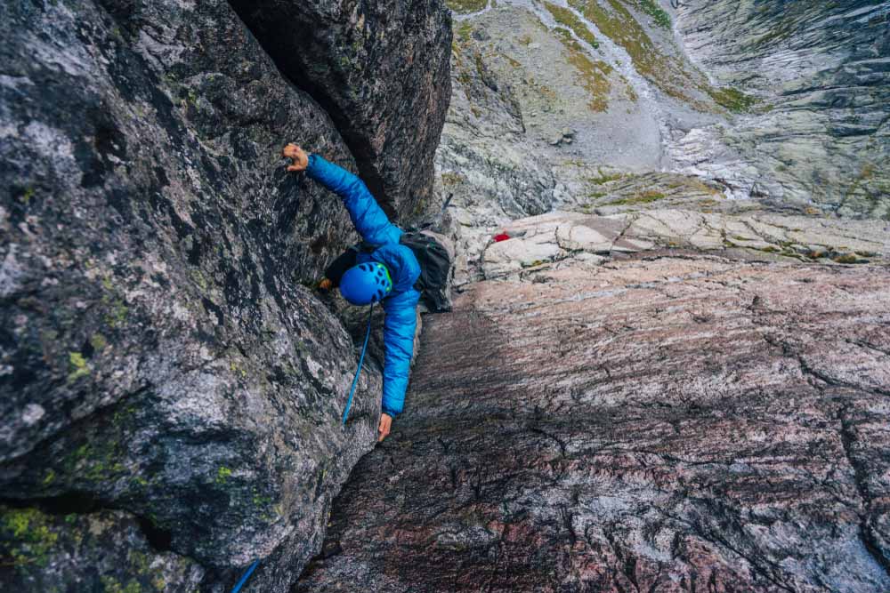 man following on a multipitch climb