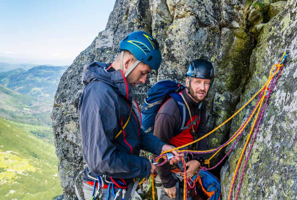 men at belay ledge during multi-pitch climbing