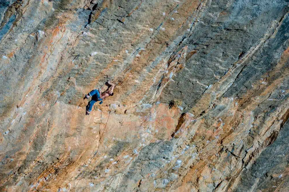 man sport climbing on steep wall