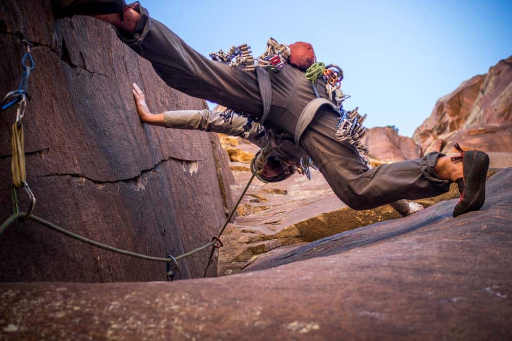 man doing trad climbing