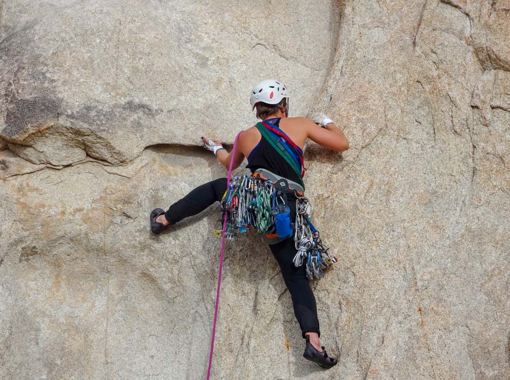 woman trad climbing