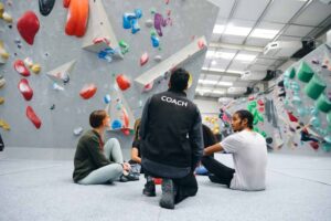 climbing coach takes with group indoors