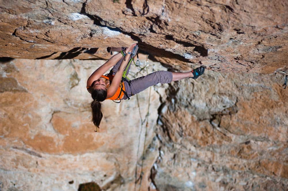woman climbing overhang in costa blanca 