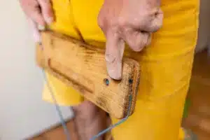 man using hangboard for finger strength training