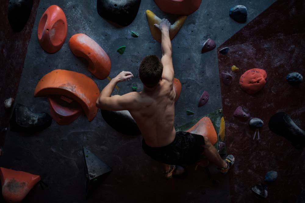 athletic man bouldering