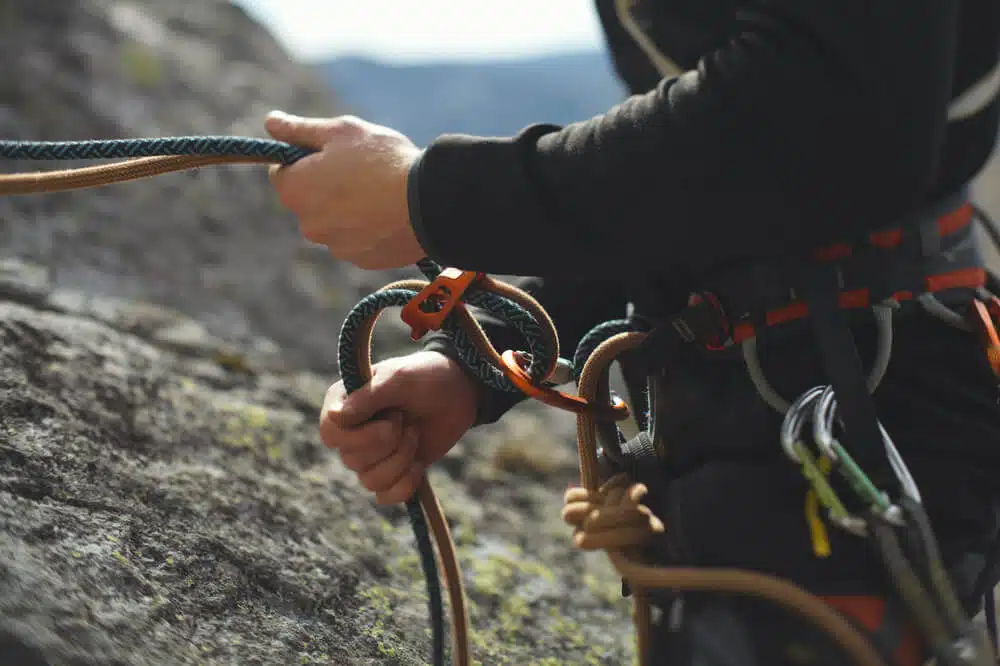 climber using double ropes with ATC