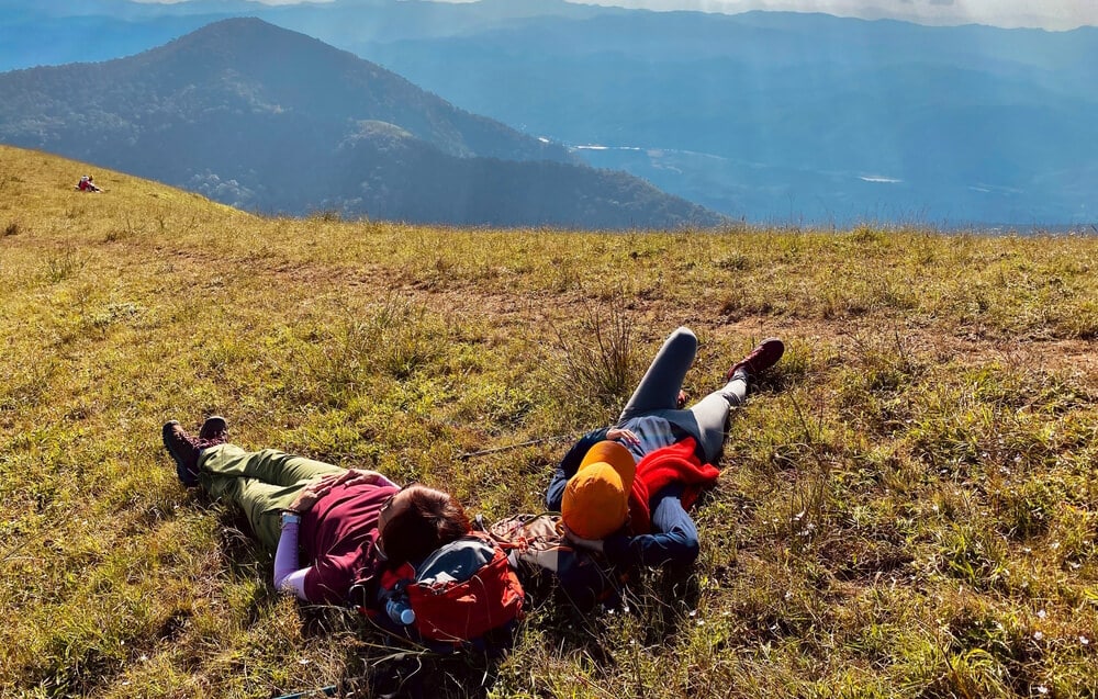 climbers relaxing on hilltop for good mental health