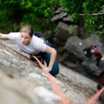 woman top rope climbing outdoors