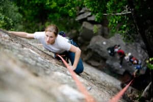 woman top rope climbing outdoors