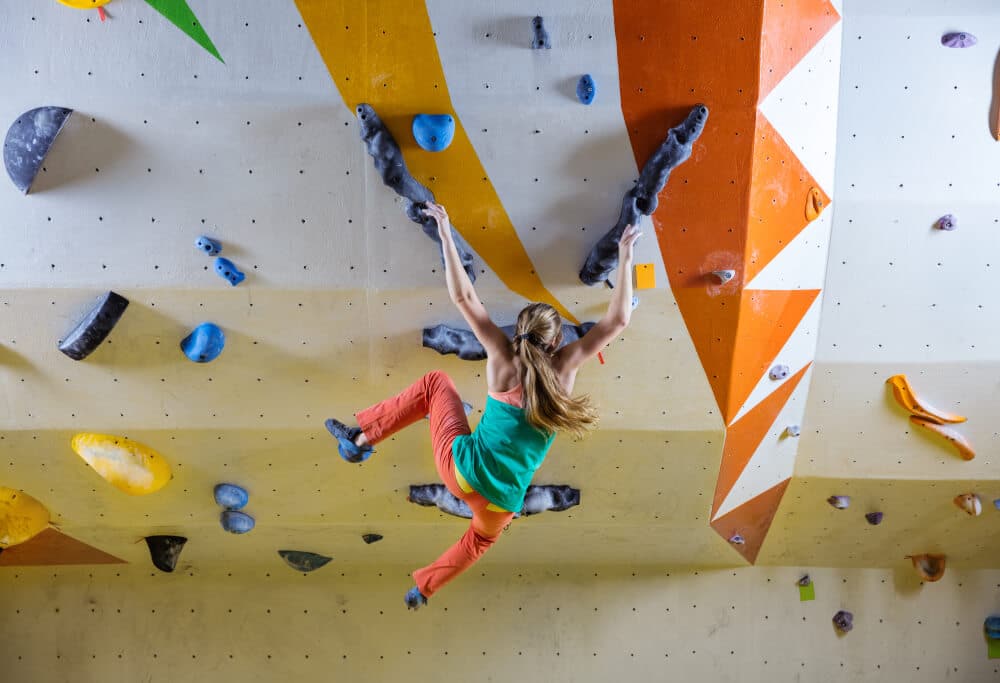 woman starting to fall when bouldering