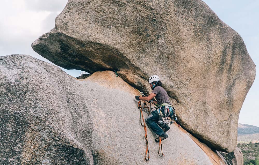 man aid climbing on slab rock