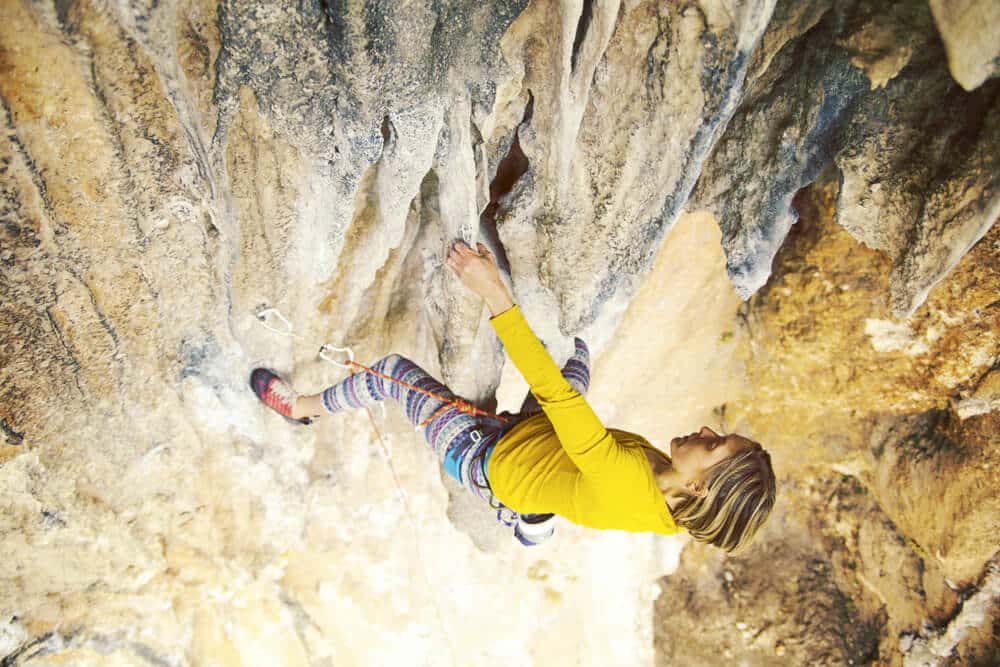 woman climbing challenging tufa