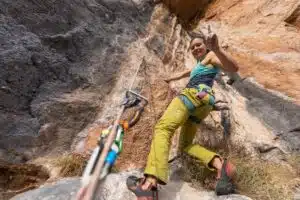 young woman at top of sport climb