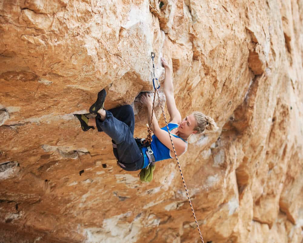 young woman on overhang sport climbing