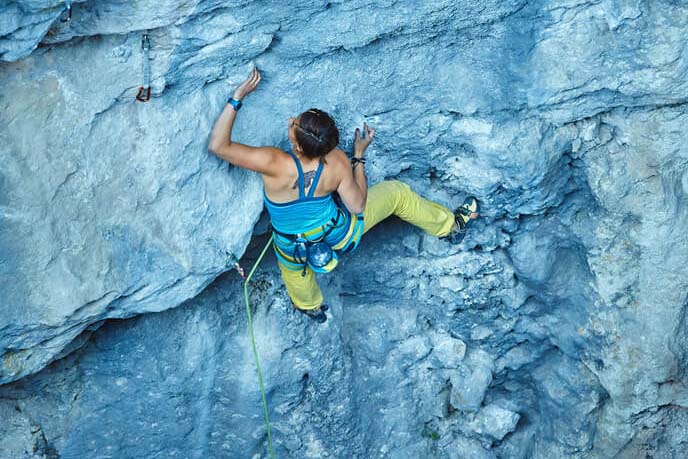 woman using gaston hold on outdoor cliff