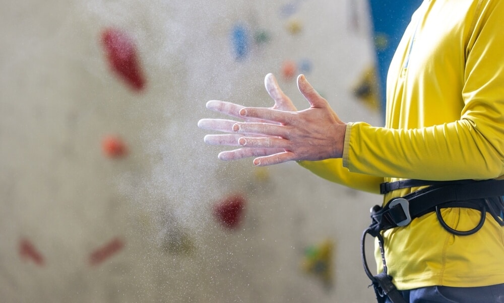 magnesium flies of male climbers hands