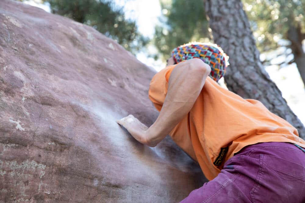 climber generating momentum to mantle up