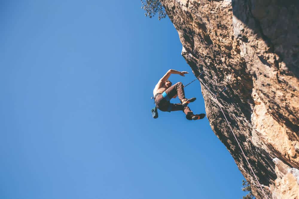 climber at the top of a cliff taking a fall