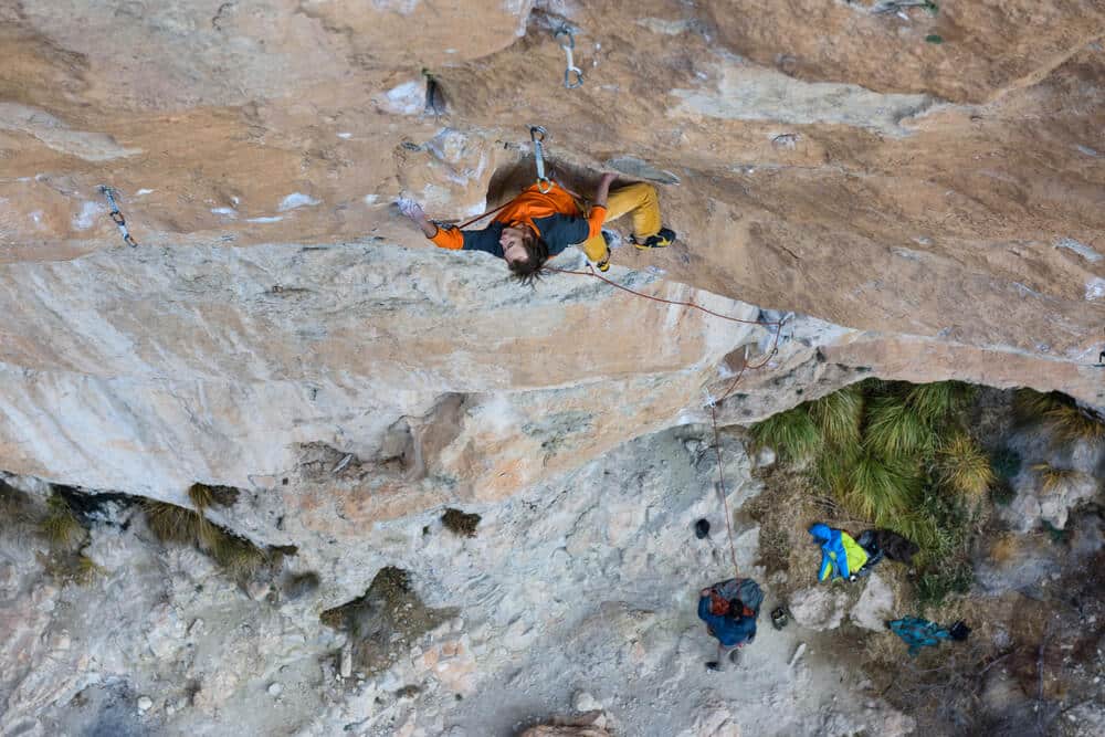 man climbing on long route outdoors