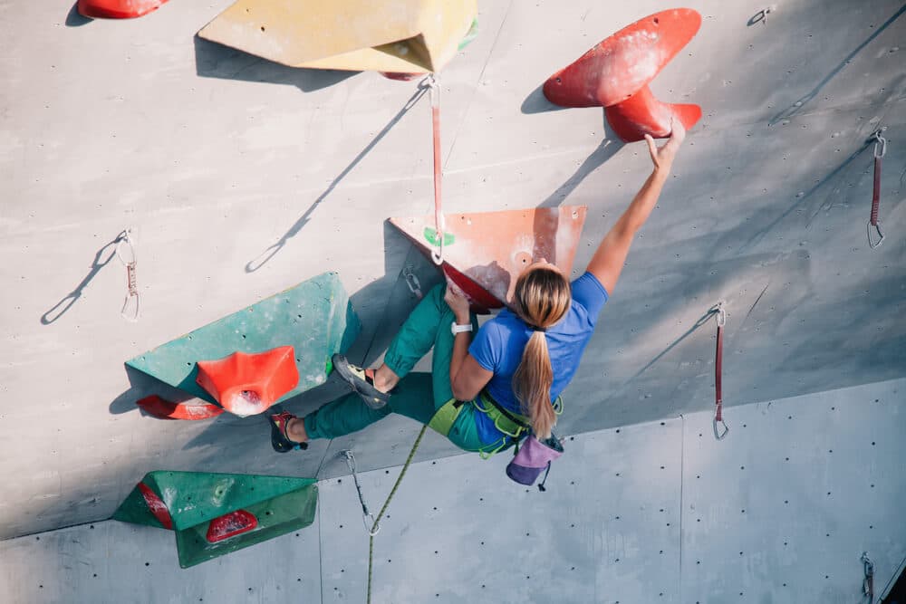 woman training power endurance on overhang on artificial wall