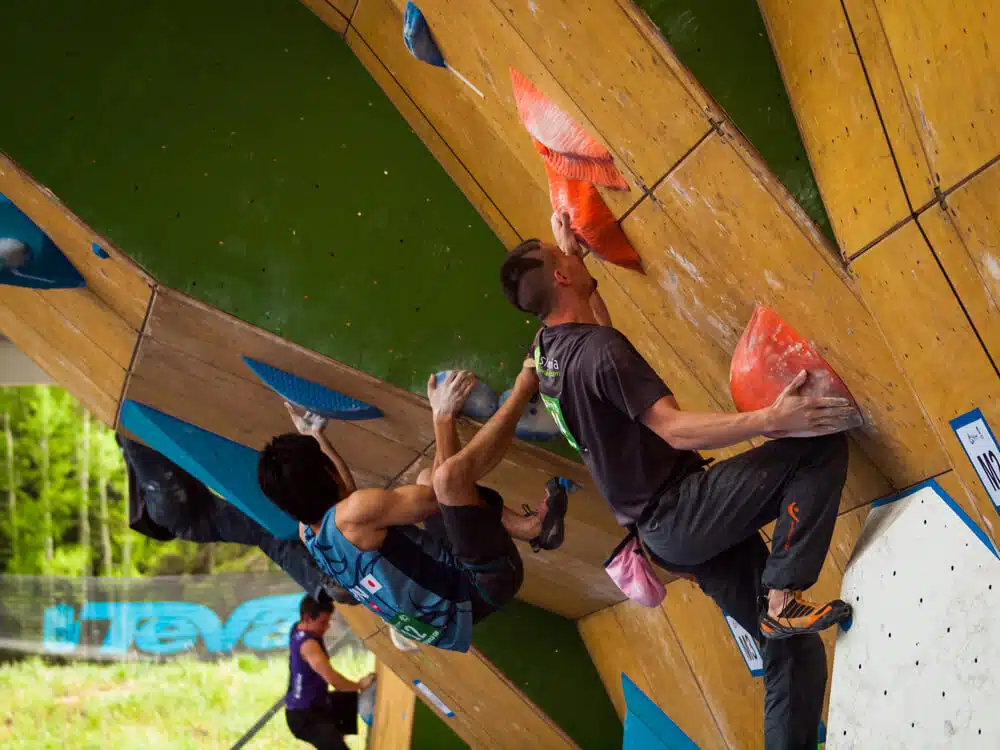 competition climbers on sloper holds on artificial wall