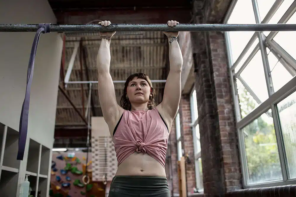 climber performing pull-ups for strength training