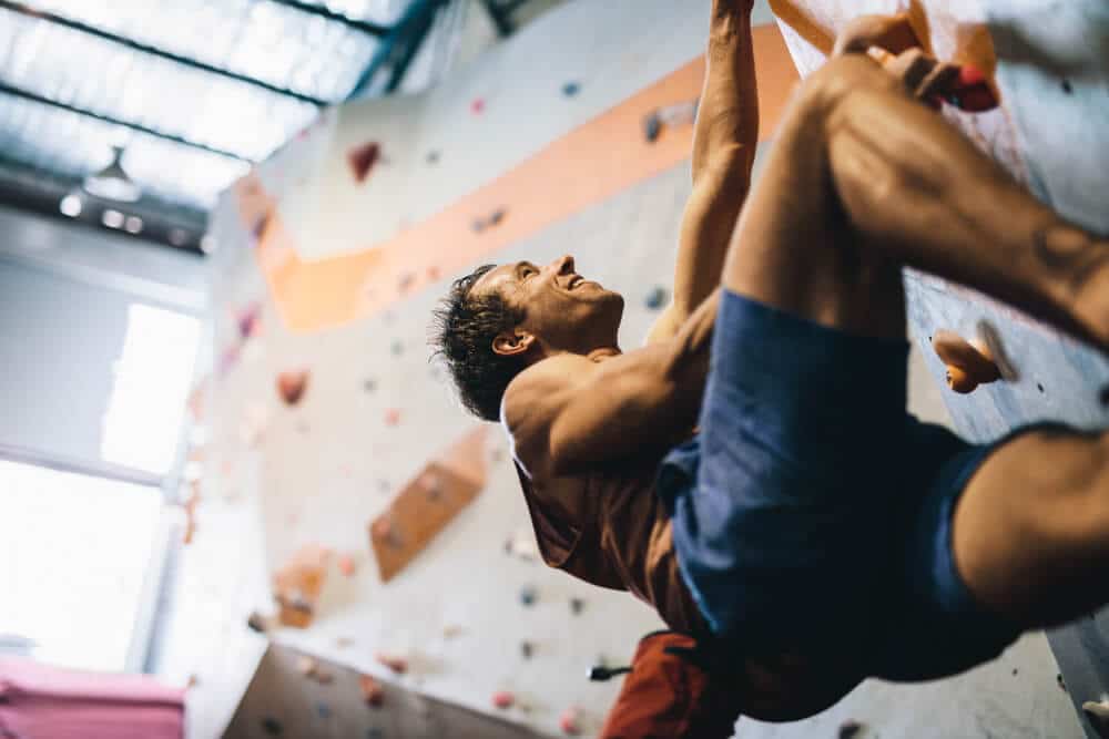 enthusiastic male climber indoors