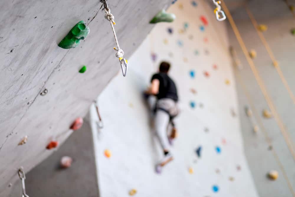 indoor climbing wall with male climber