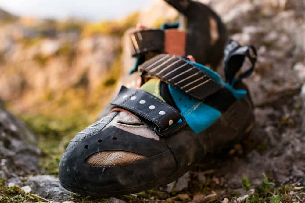 worn pair of scarpa climbing shoes